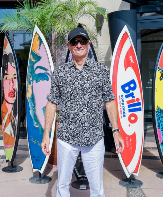 photo of an artist and his surf boards taken by Black X Marketing for client La Jolla By The Sea